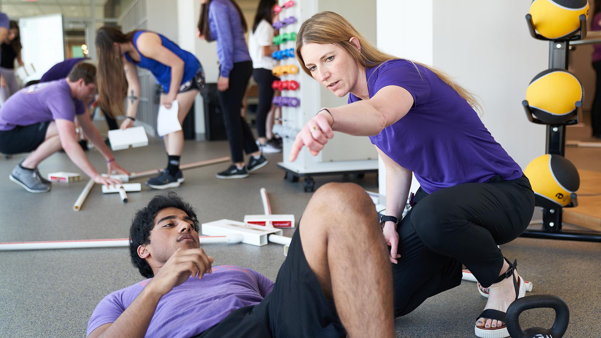 Physical Therapy student with patient stretching